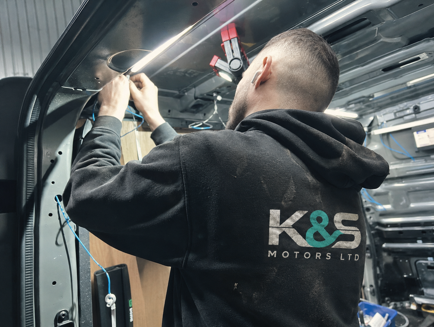 K&S Motors technician at work in a vehicle